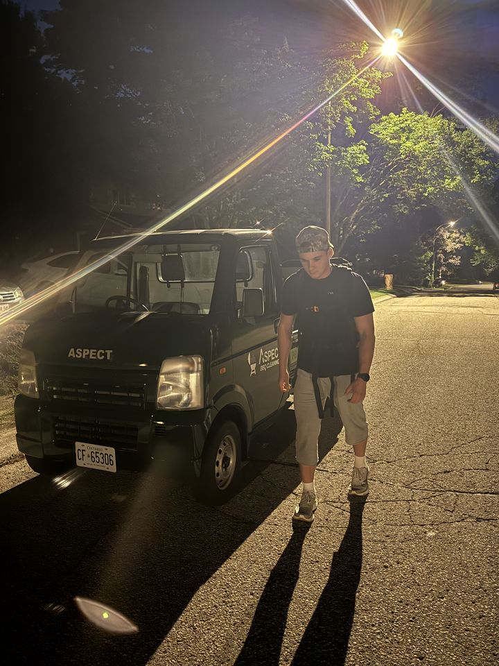 Jacob walking past the Aspect BBQ Cleaning truck at dusk