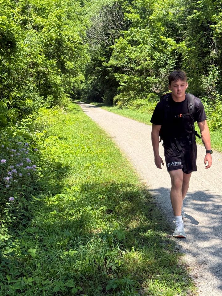 Jacob rucking toward the camera on the rail trail